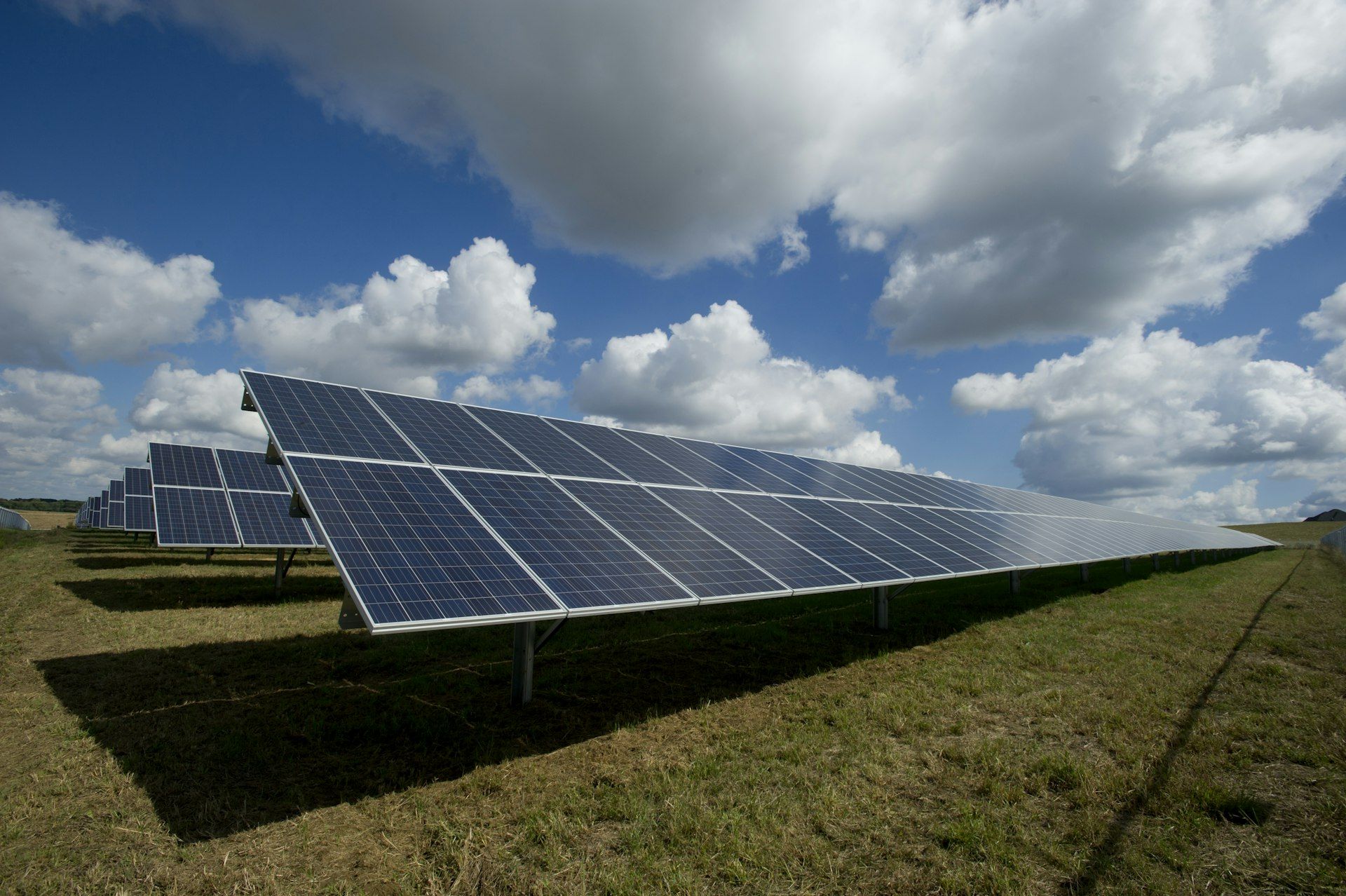 Solar panels on a commercial rooftop under clear sky